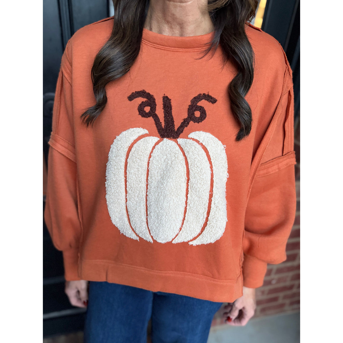 Annie Ks Boutique vintage rust pullover featuring a plush white textured pumpkin patch and relaxed drop shoulders.