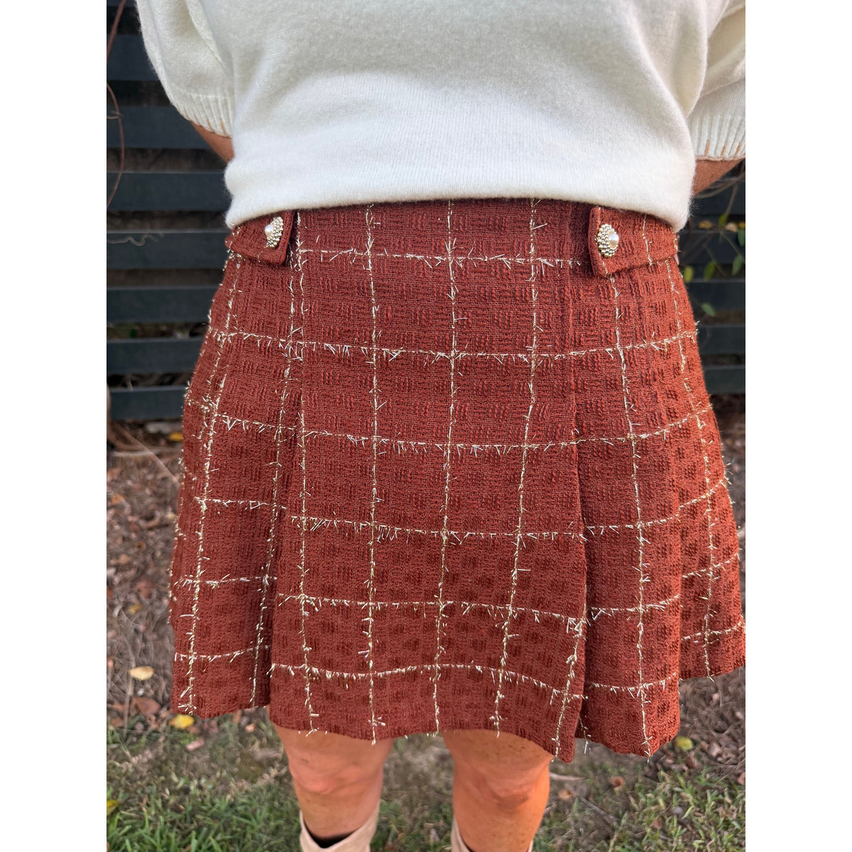 Annie Ks Boutique rust tweed skort with a white grid pattern, decorative jewel buttons, and a structured fit.