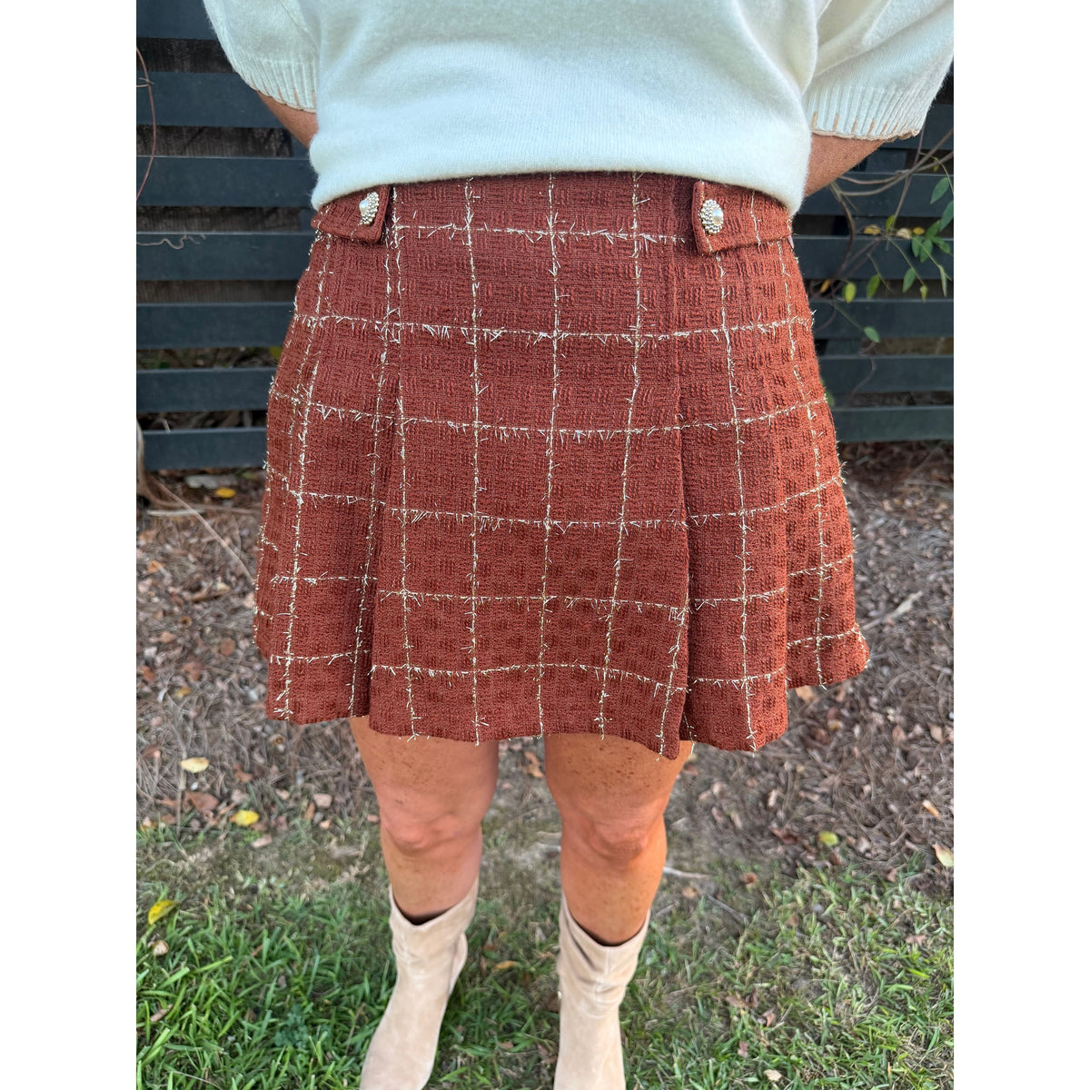 Annie Ks Boutique rust tweed skort with a white grid pattern, decorative jewel buttons, and a structured fit.