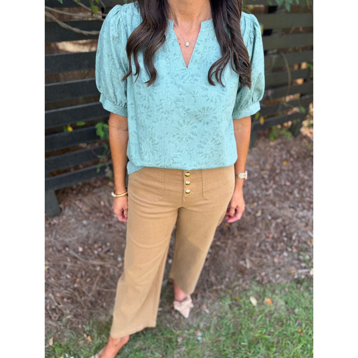 Annie Ks Boutique sage textured puff sleeve blouse paired with tan button-front wide-leg trousers