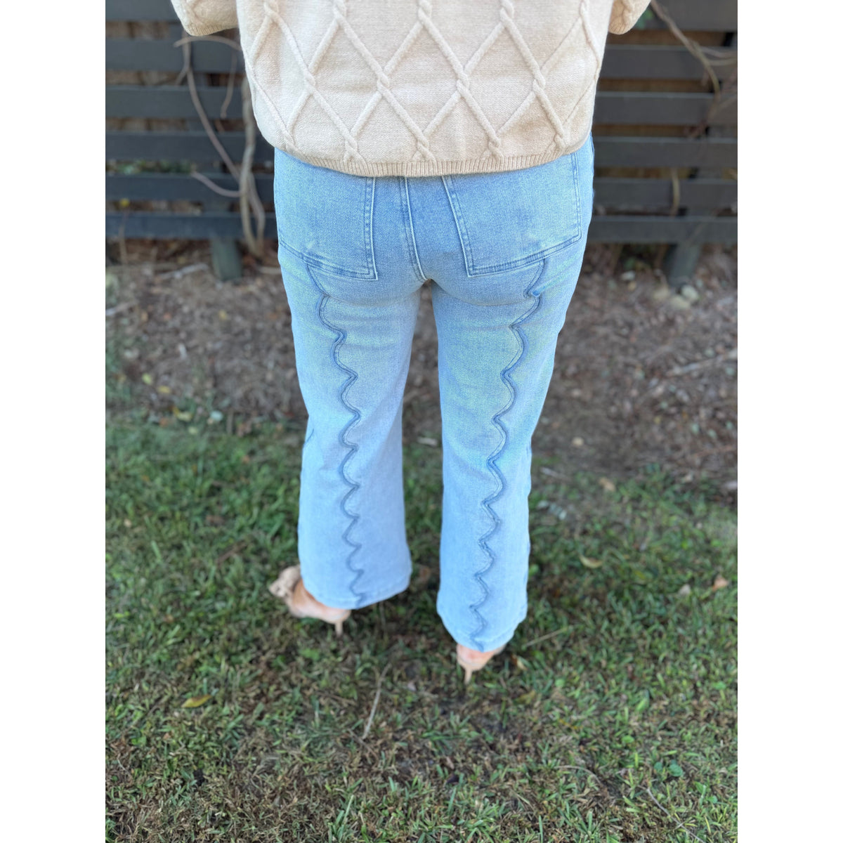 Annie Ks Boutique light wash wide leg denim jeans featuring unique vertical scalloped seam detailing on the back