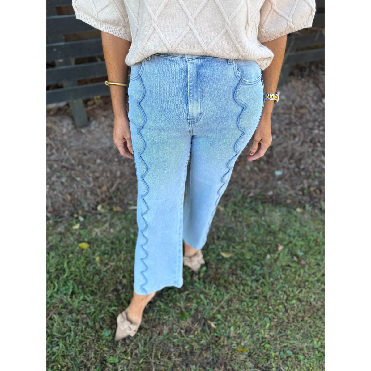 Annie Ks Boutique light wash wide leg denim jeans featuring unique vertical scalloped seam detailing on the front