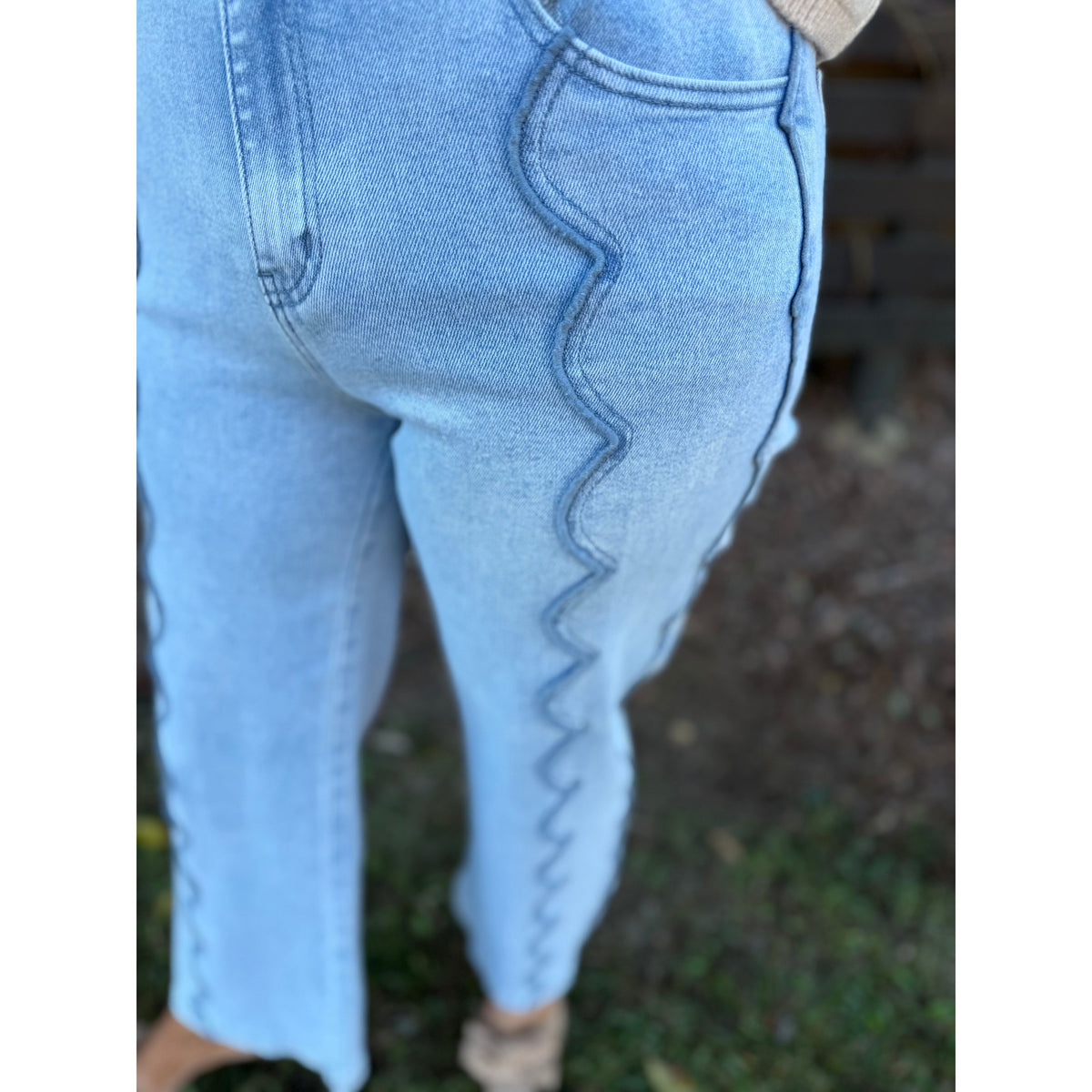 Annie Ks Boutique light blue wide leg denim jeans featuring unique scalloped seam detailing on the front legs.