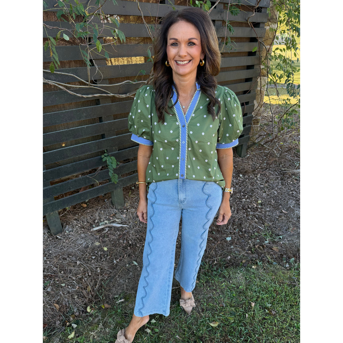 Annie Ks Boutique model wearing high-rise wide-leg denim jeans with unique scalloped seam detailing in a light wash.