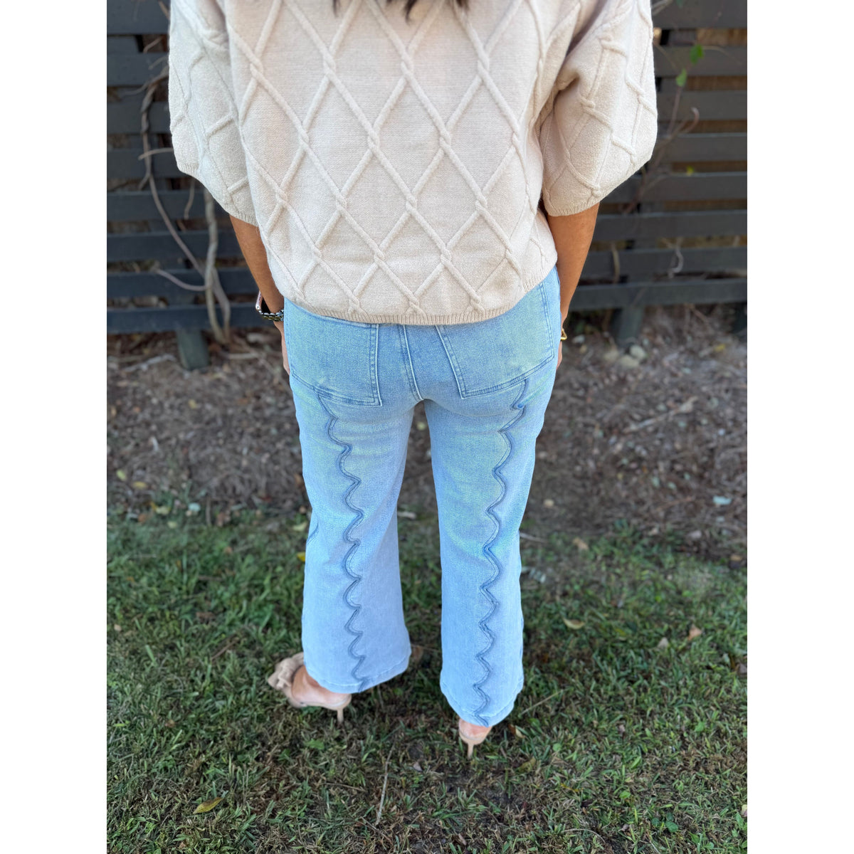 Annie Ks Boutique wide leg denim jeans featuring unique scalloped seam detailing on the back, worn with a beige sweater
