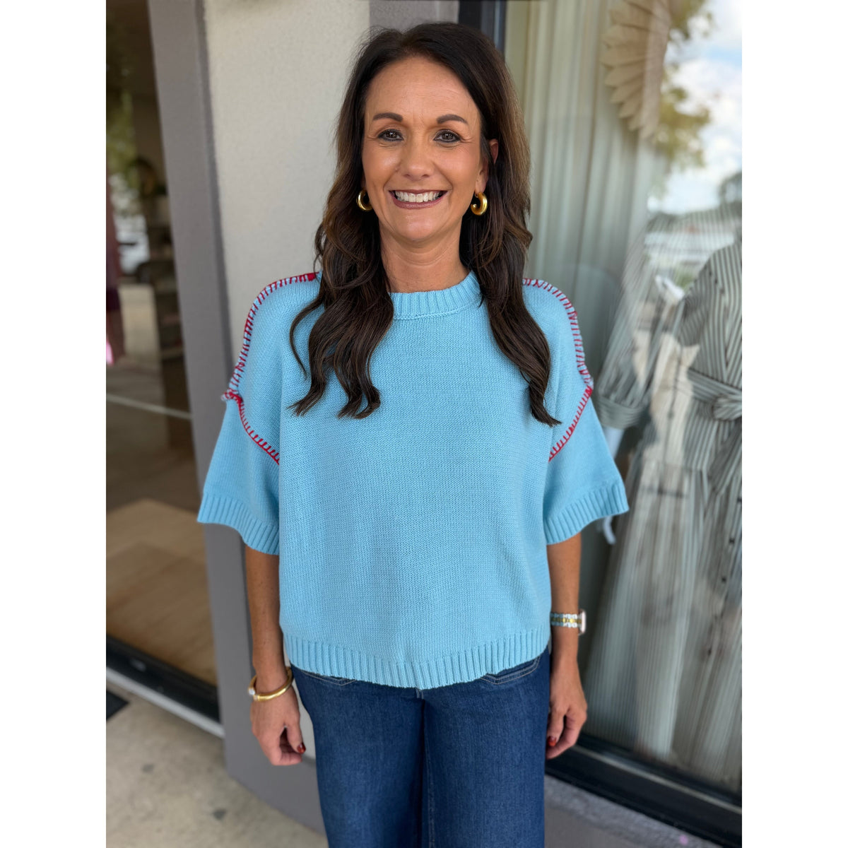 Annie Ks Boutique sky blue short sleeve sweater with red blanket stitch detail on shoulders and ribbed neckline