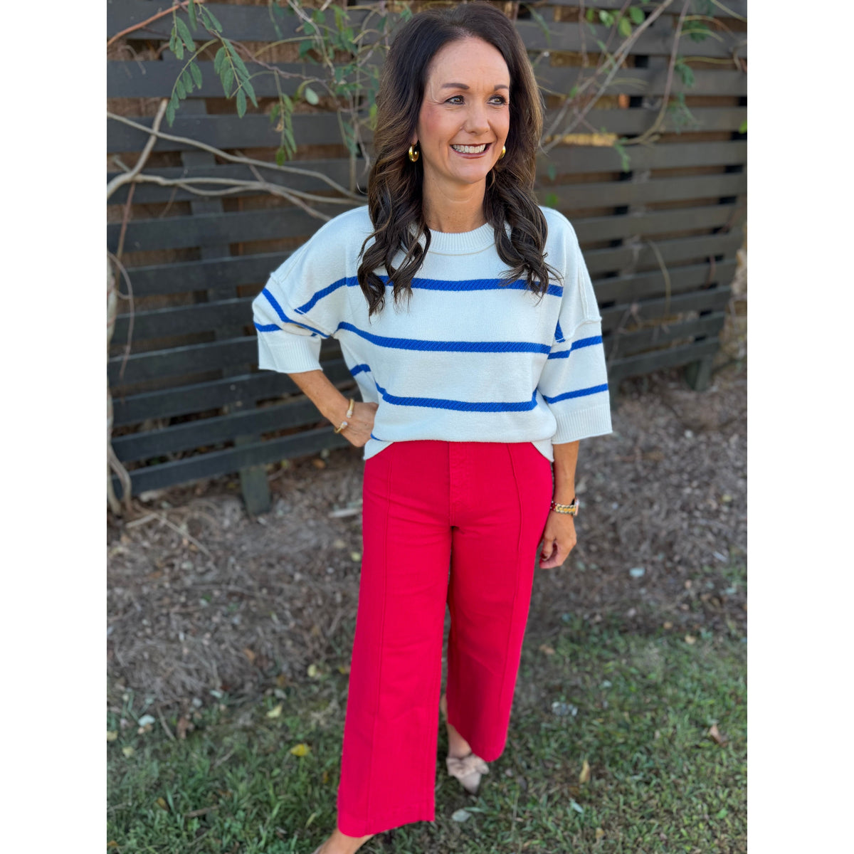 Annie Ks Boutique oversized white and blue striped crew sweater with dropped shoulders and ribbed trim on a woman