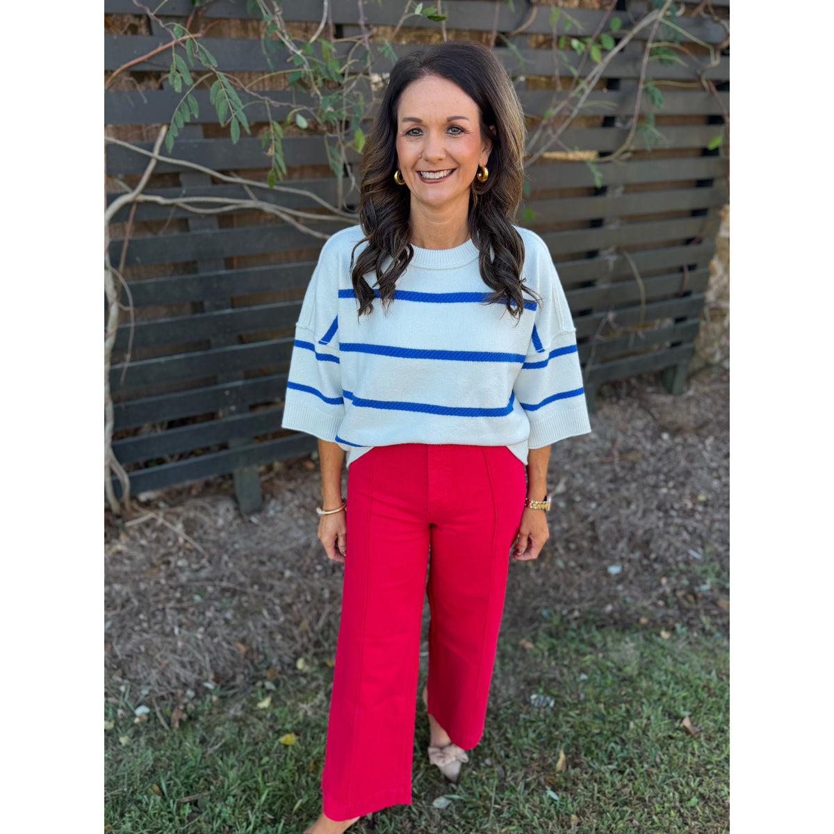 Annie Ks Boutique oversized white and blue striped crew sweater with dropped shoulders worn with bright red trousers