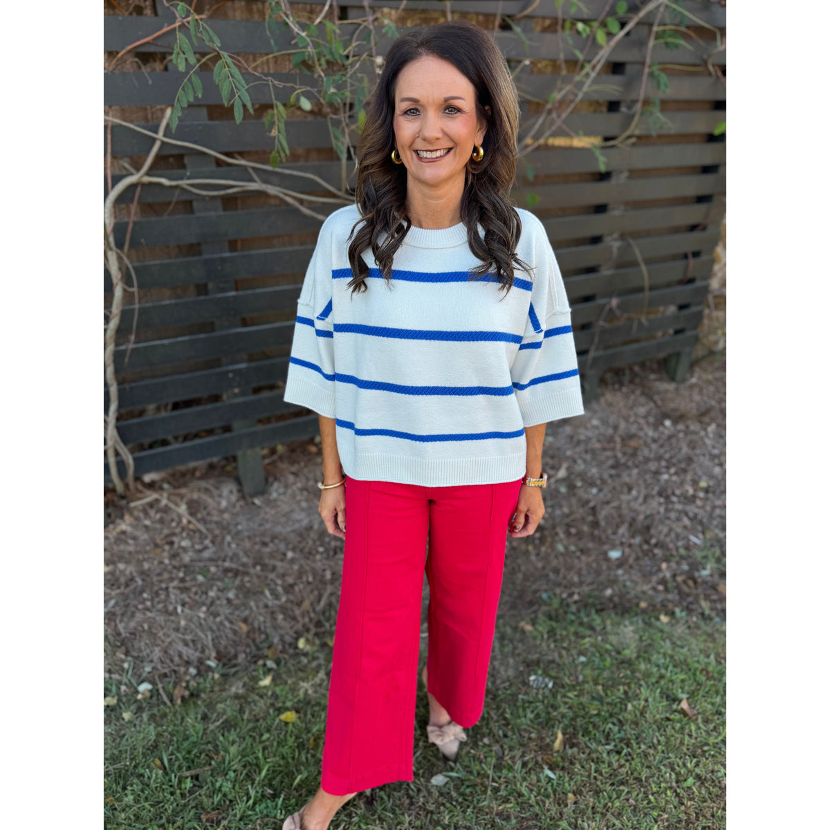 Annie Ks Boutique oversized white and blue striped crew sweater with dropped shoulders worn with red trousers