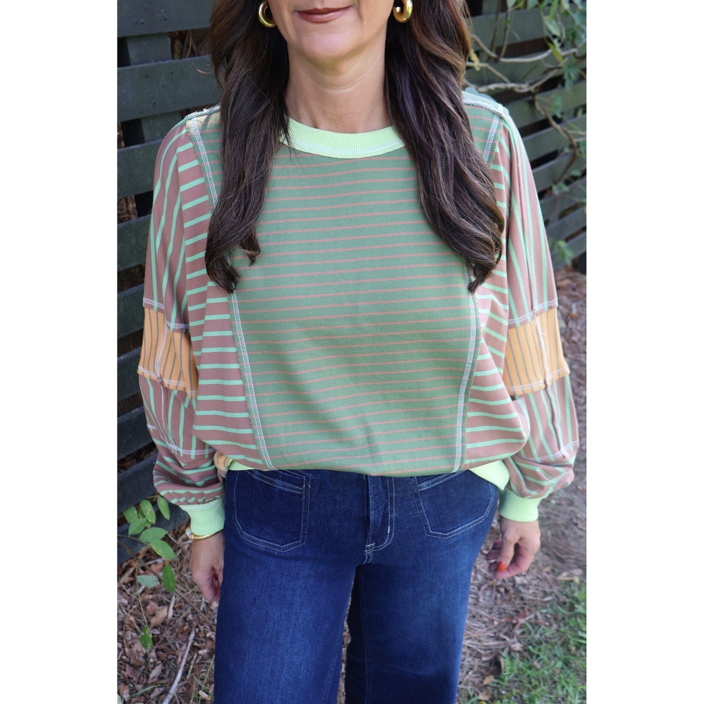 Annie Ks Boutique loose fit top featuring olive and latte mixed stripes with contrasting sleeve panels and ribbed trim
