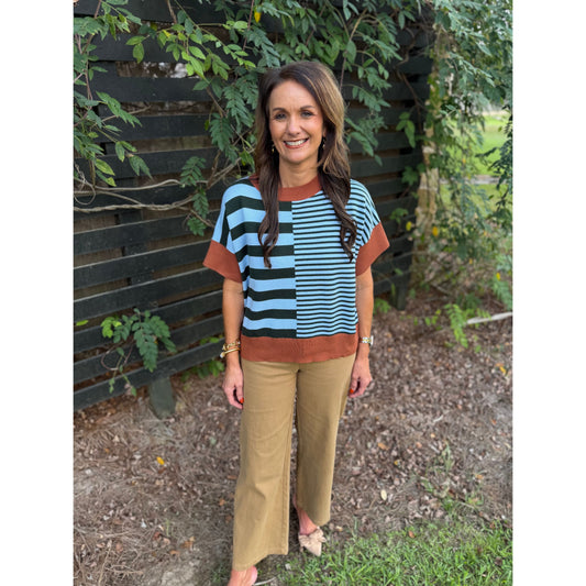 Annie Ks Boutique model wearing a caramel and sea green striped drop-shoulder sweater with wide-leg trousers.