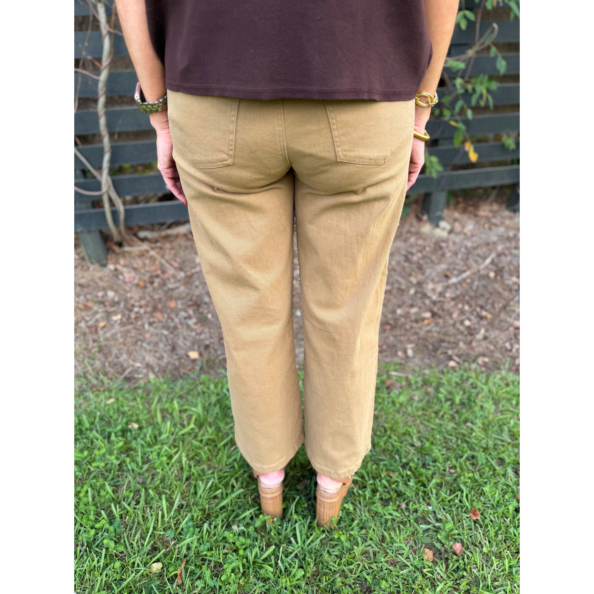 Annie Ks Boutique tan wide-leg trousers viewed from the back, featuring functional pockets and a cotton-blend fabric.