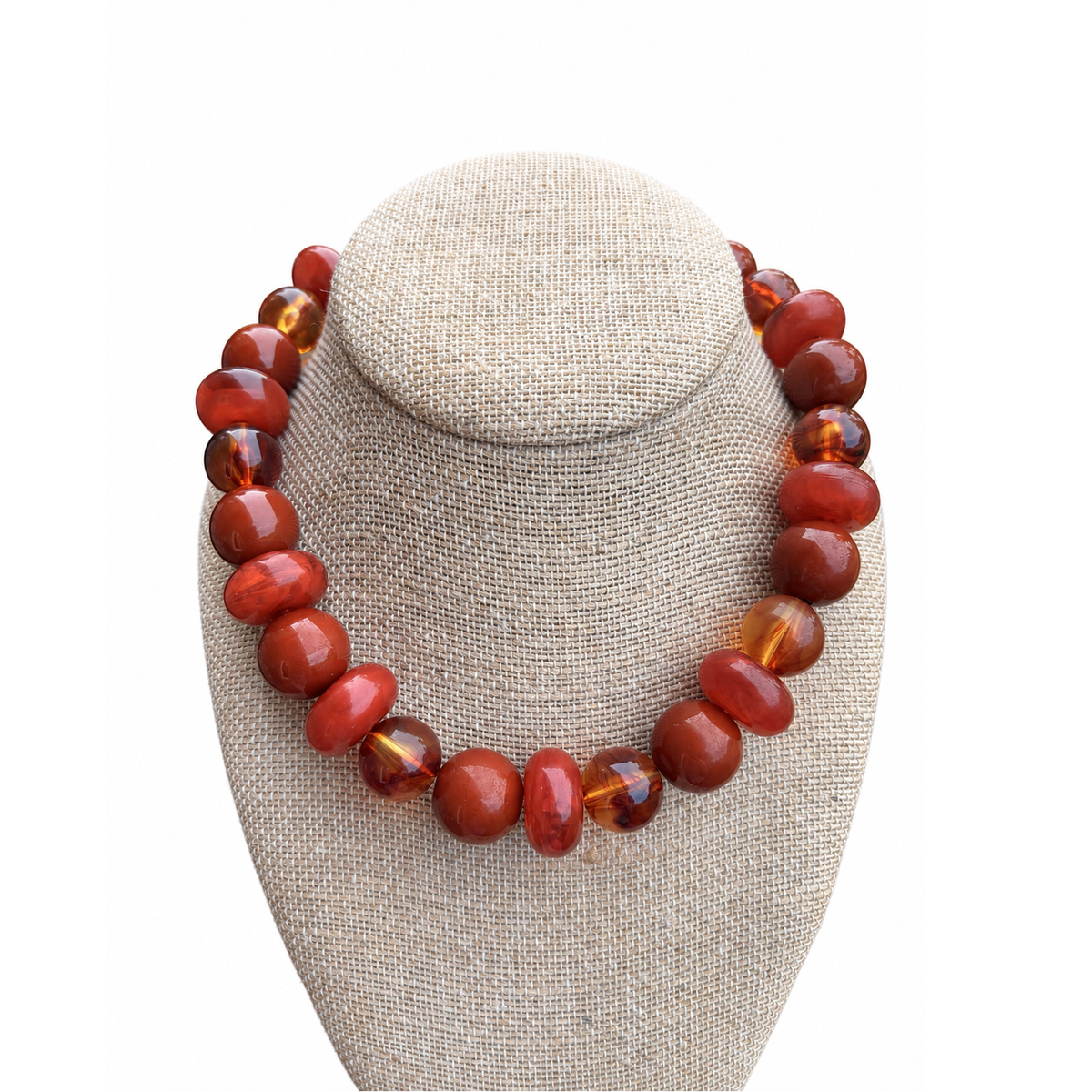 Annie Ks Boutique terracotta statement necklace with glossy round and disc beads in rust and amber tones on a display