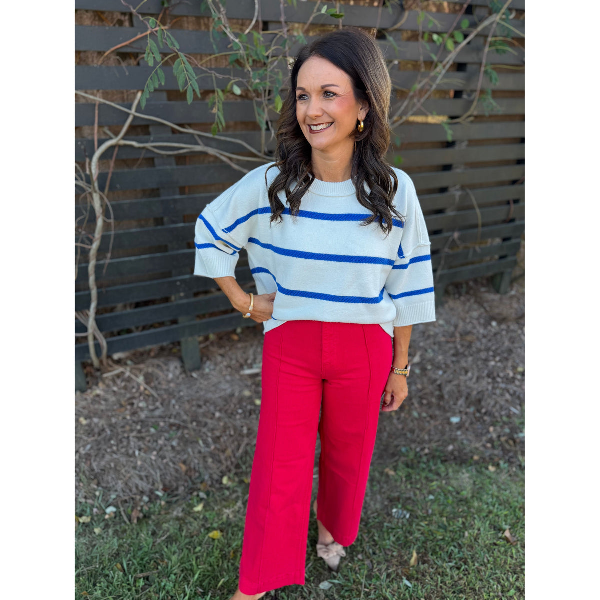 Annie Ks Boutique oversized white and blue striped crew sweater with dropped shoulders paired with red trousers