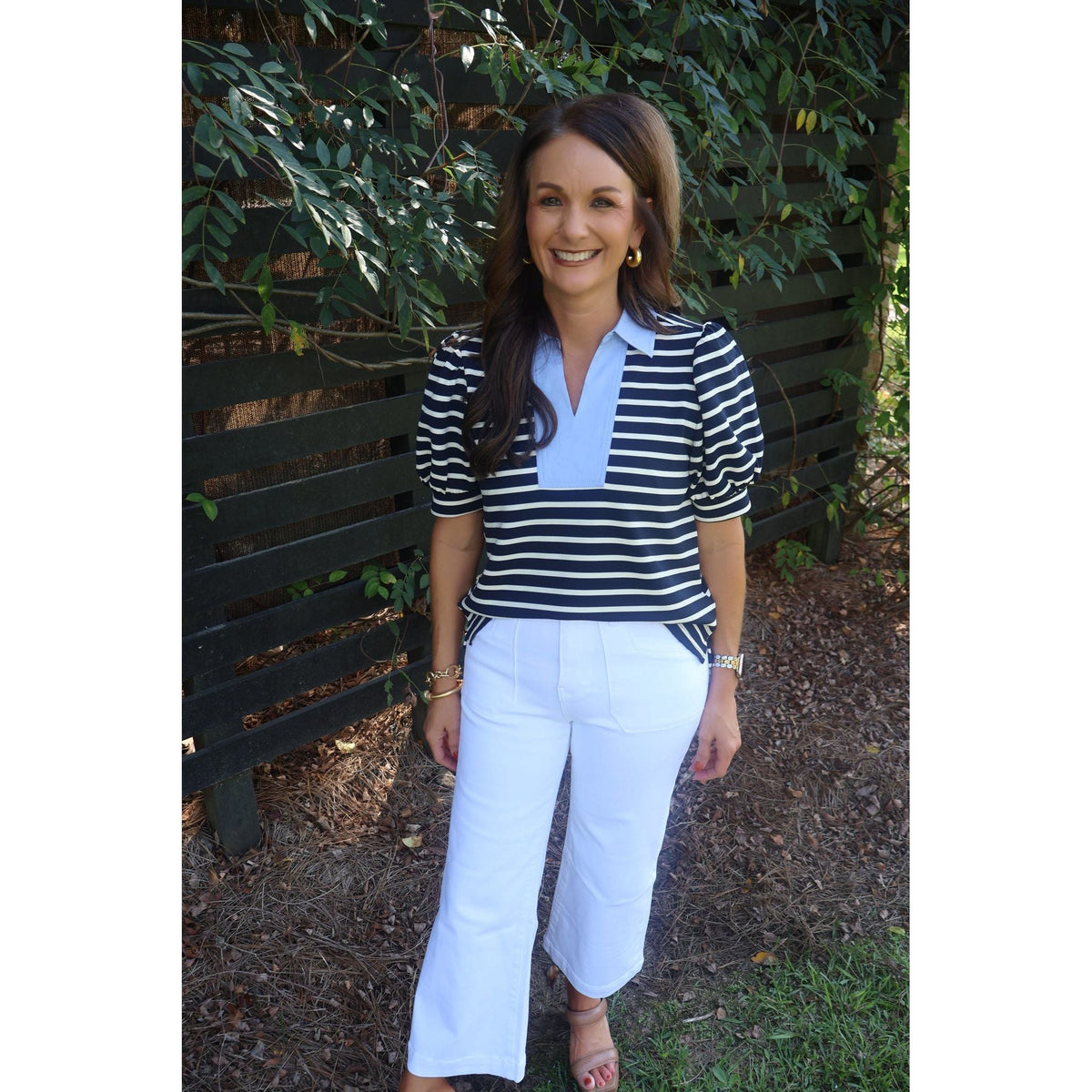 Annie Ks Boutique model wearing white super high rise wide leg pants with a striped puff sleeve polo shirt
