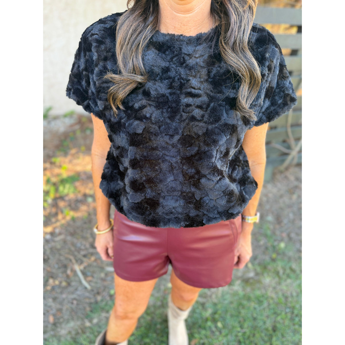 Annie Ks Boutique wine faux leather shorts with pintuck detail paired with a black textured faux fur top