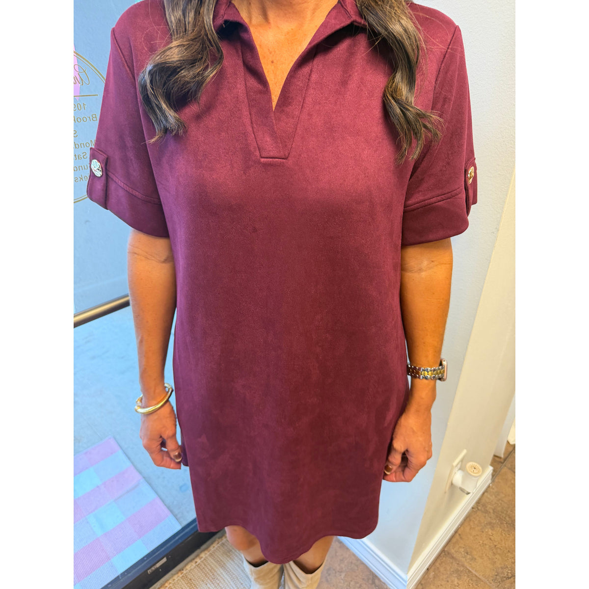 Annie Ks Boutique wine faux suede mini dress with a collared neckline and short sleeves featuring button details.