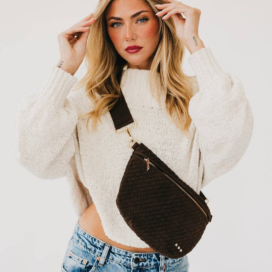 Annie Ks Boutique Westlyn woven chocolate brown vegan suede bum bag worn as a stylish crossbody by a blonde model.
